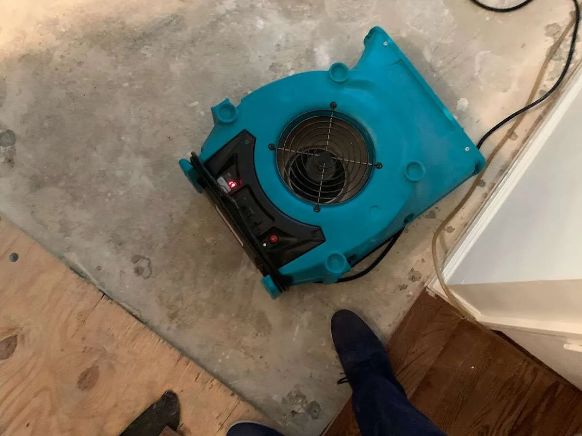 Air mover drying subfloor during Commercial Water Damage Restoration in Pennfield